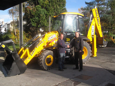 All new JCB 3CX Sitemaster Facelift machine with newly designed cab, front loader and backhoe. James Atley from Holt JCB proudly presents Steve Friend (operator) with the keys to the first new machine delivered in the South West.