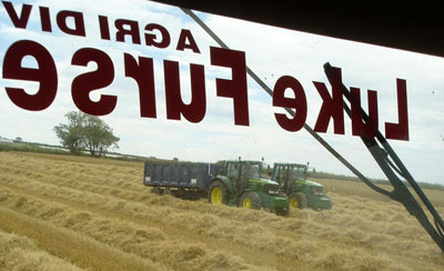 John Deere Tractors hauling grain back to the CMI store